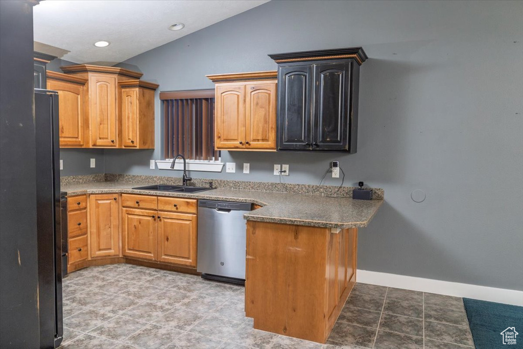 Kitchen with baseboards, vaulted ceiling, a peninsula, stainless steel dishwasher, and a sink