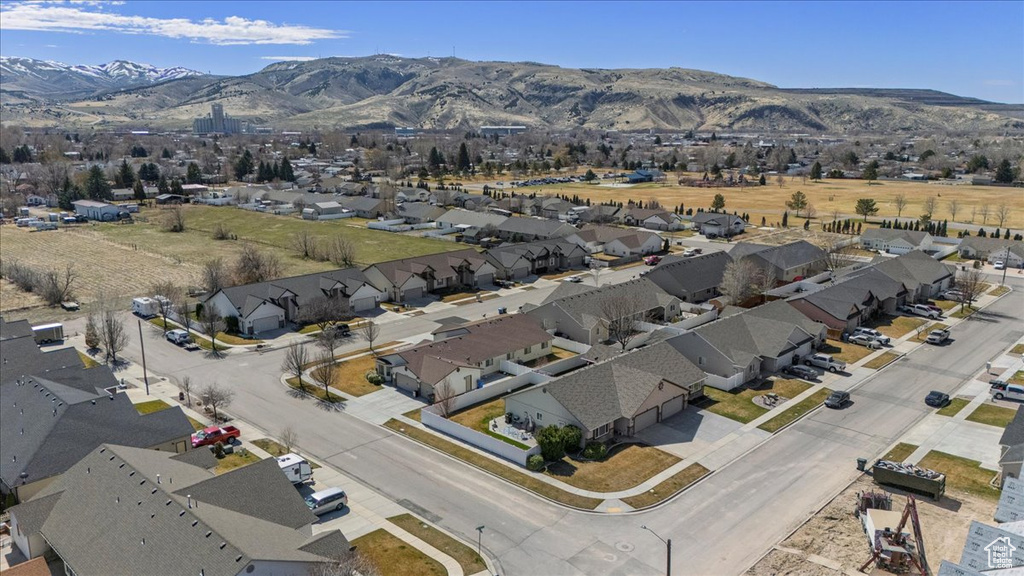 Birds eye view of property with a residential view and a mountain view