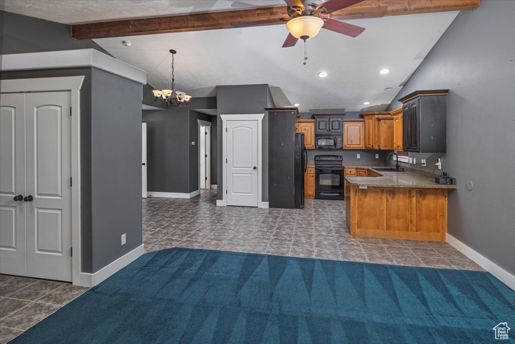 Kitchen featuring baseboards, lofted ceiling with beams, black appliances, ceiling fan with notable chandelier, and a sink