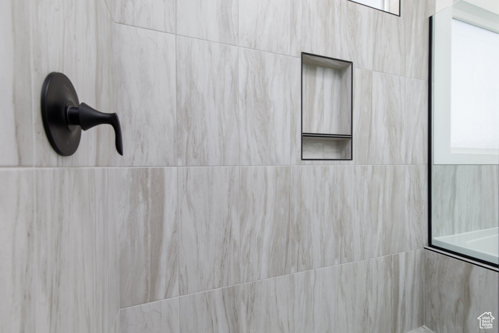 Room details featuring a tile shower