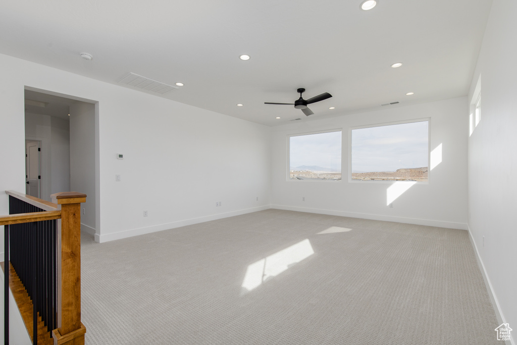 Spare room with recessed lighting, light colored carpet, baseboards, and ceiling fan