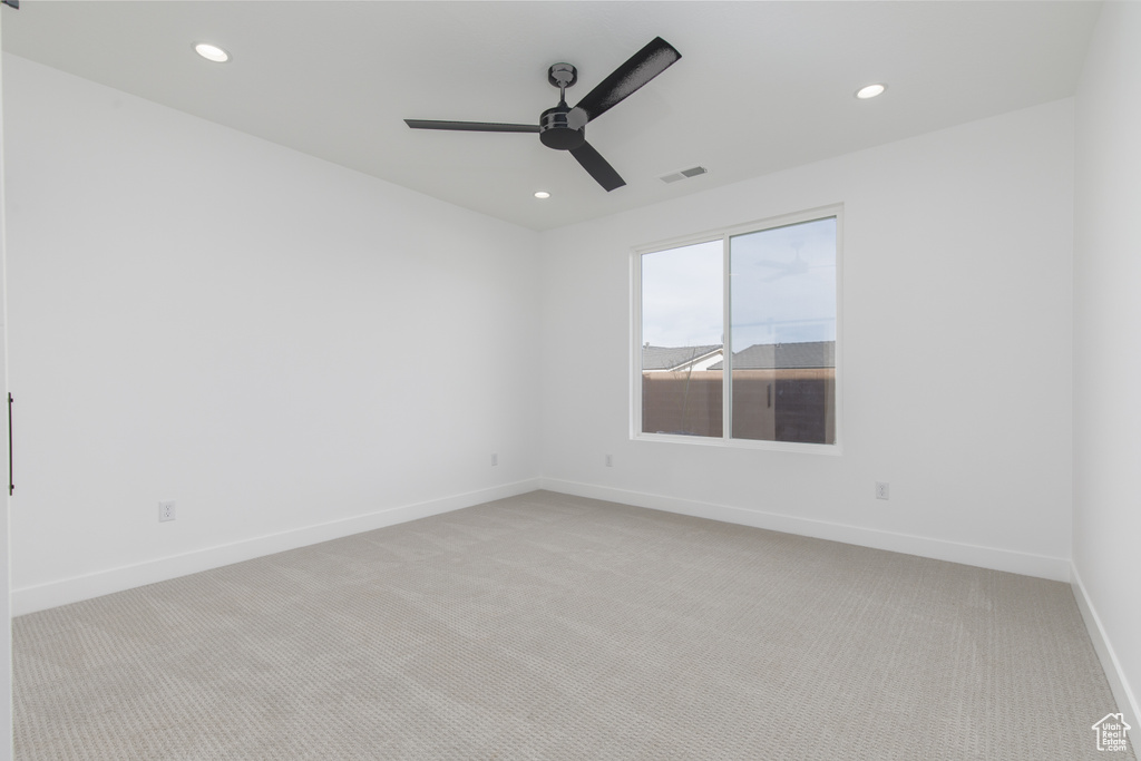 Spare room with baseboards, light carpet, recessed lighting, a ceiling fan, and visible vents