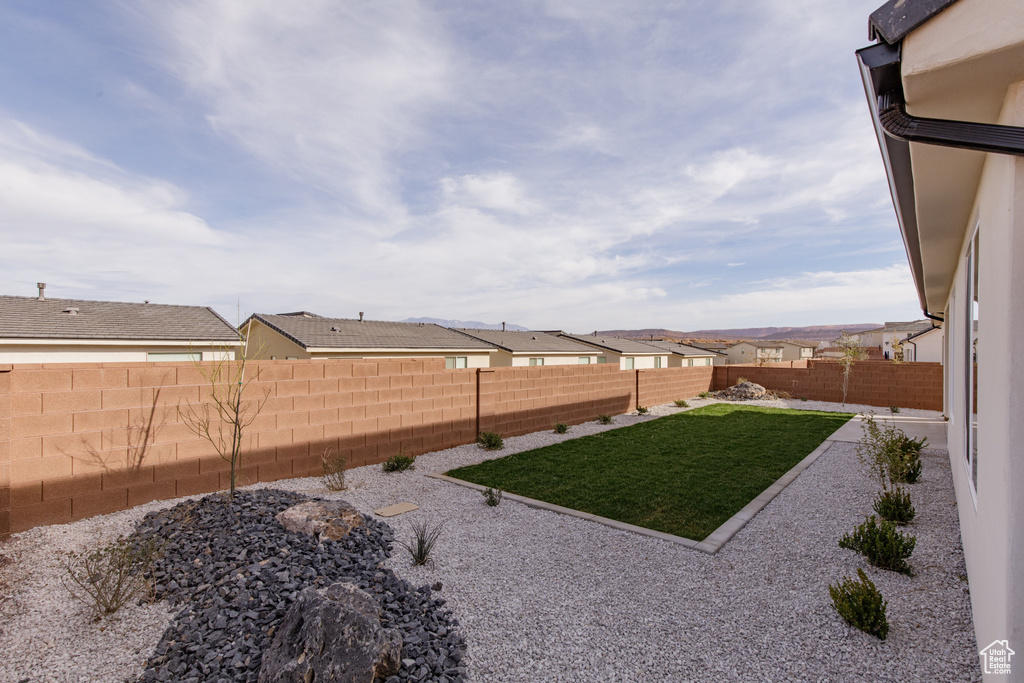 View of yard with a fenced backyard and a residential view