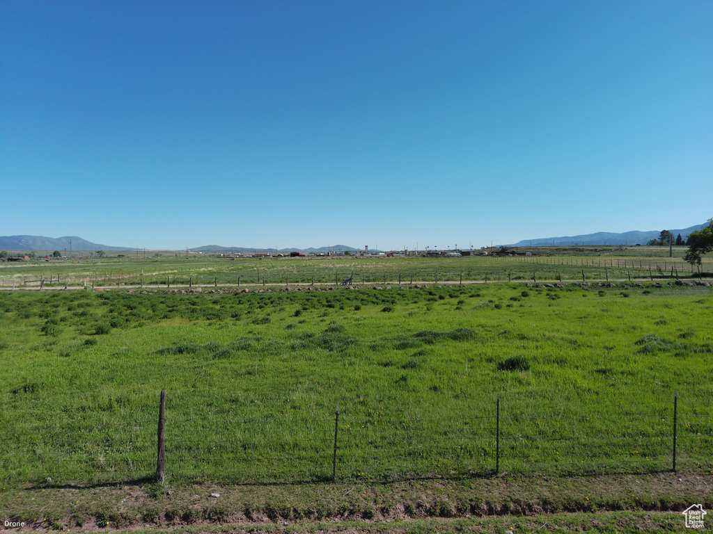 View of yard featuring a view of rural / pastoral area and a mountain view