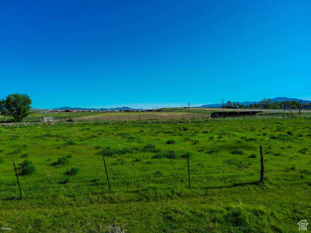 View of yard featuring a view of rural / pastoral area and a mountain view