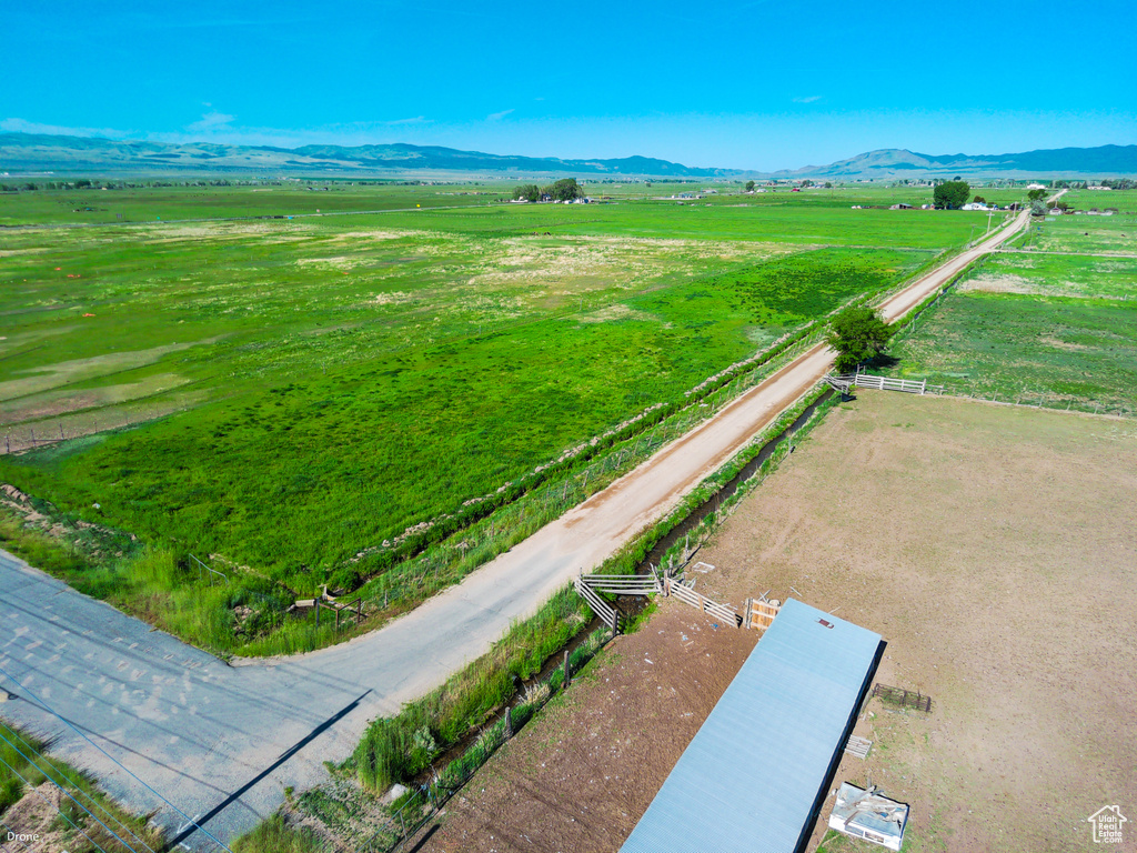 Aerial view of sparsely populated area with agricultural land and a mountainous background