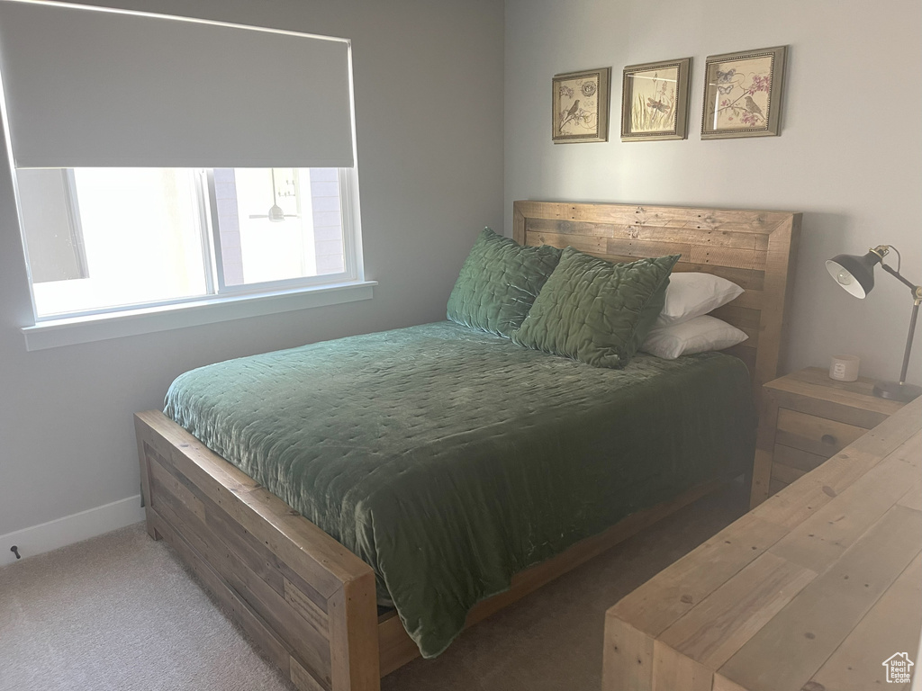 Carpeted bedroom with baseboards