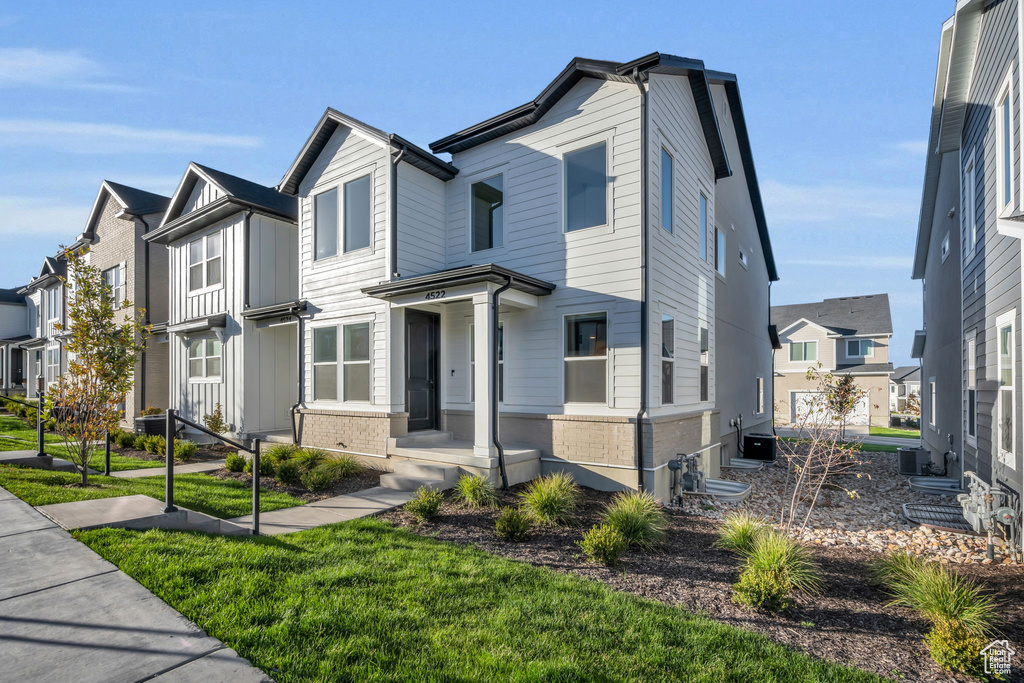 View of front of home with a residential view and brick siding