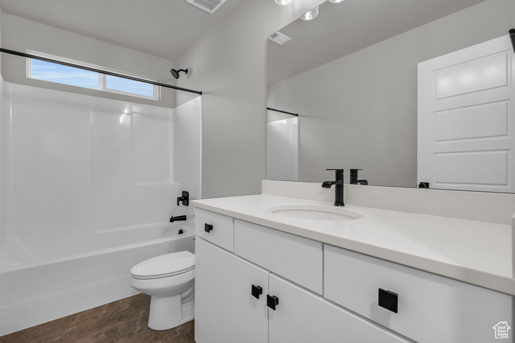 Full bath featuring toilet, visible vents, vanity, and tub / shower combination