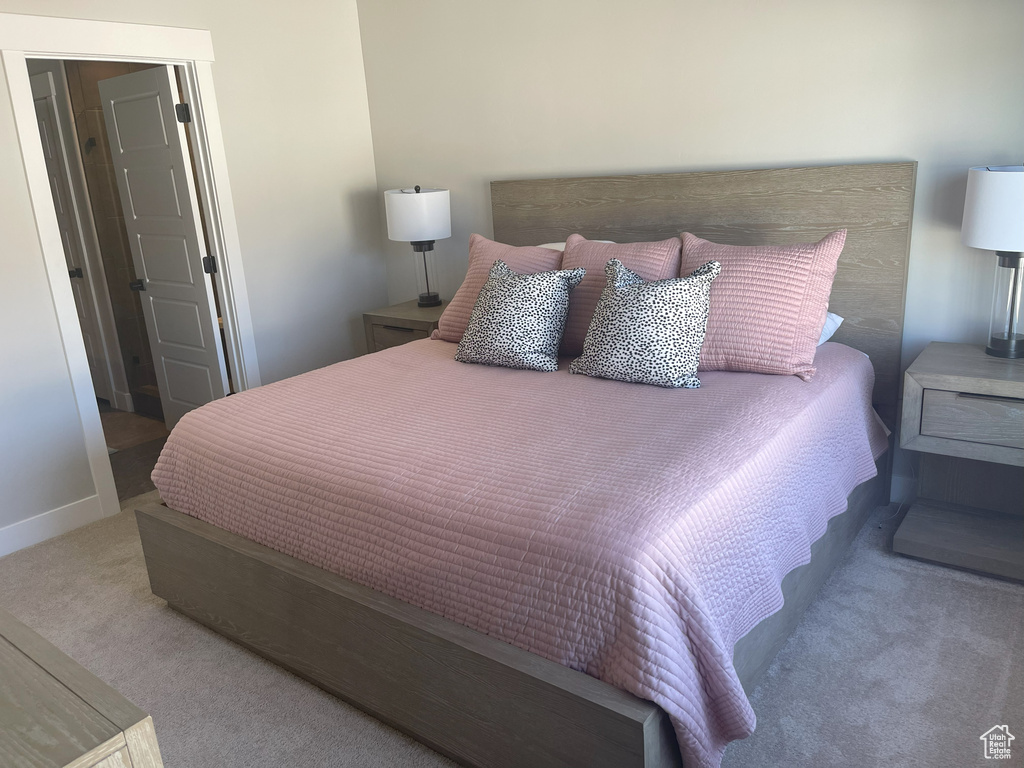 Bedroom featuring baseboards and carpet