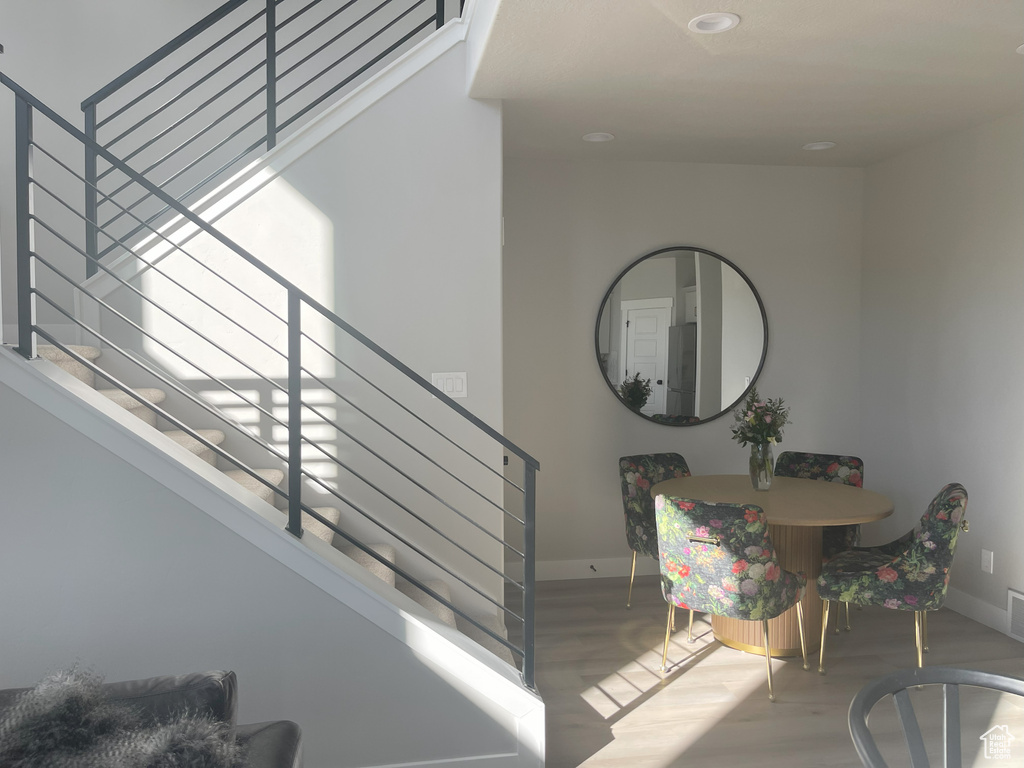Stairs with visible vents, baseboards, and wood finished floors