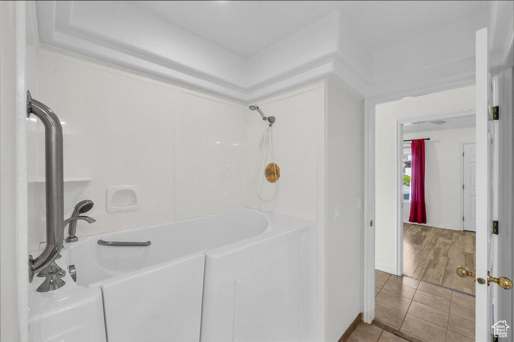 Bathroom featuring a bathing tub, tile patterned floors, and a shower