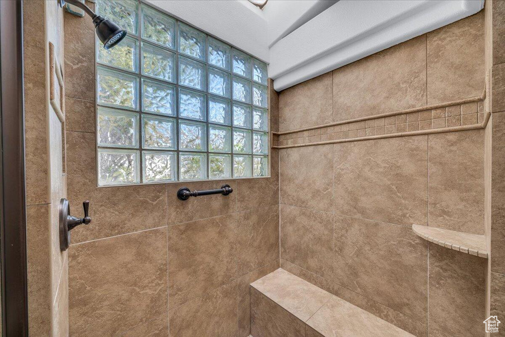 Full bath featuring a tile shower