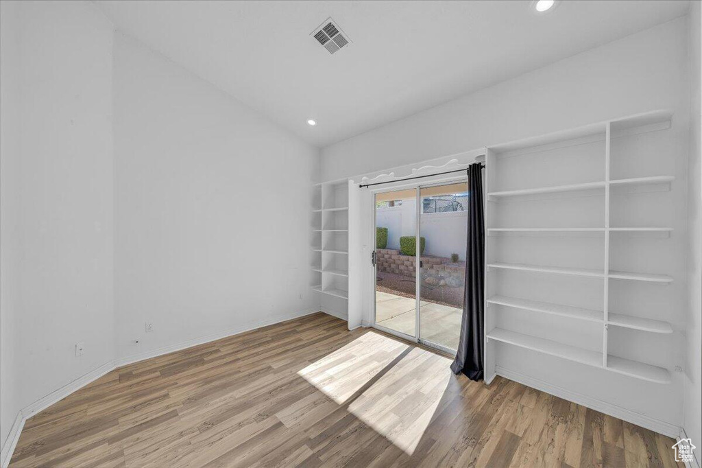Unfurnished room featuring recessed lighting, visible vents, and wood finished floors