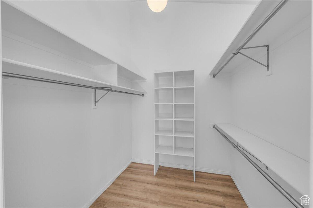 Spacious closet with light wood-style flooring