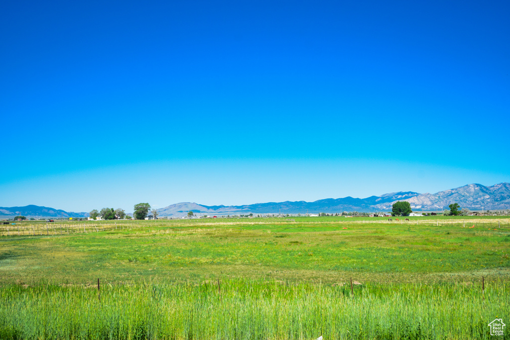 View of mountain backdrop with rural landscape and agricultural land
