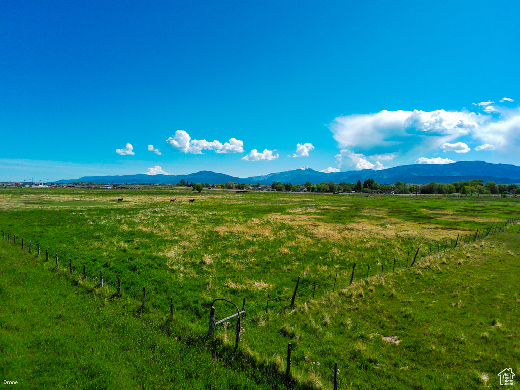 View of mountain backdrop featuring rural landscape and agricultural land