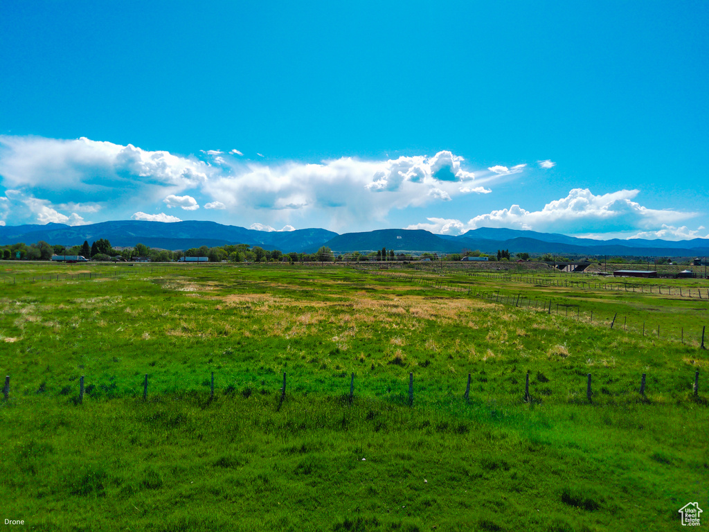View of mountain backdrop featuring rural landscape and agricultural land
