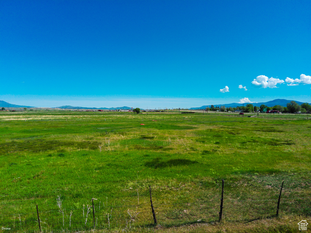 View of undeveloped land with rural landscape, a mountain backdrop, and a pastoral area