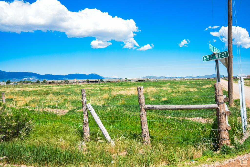 View of yard featuring a view of rural / pastoral area and a mountain view