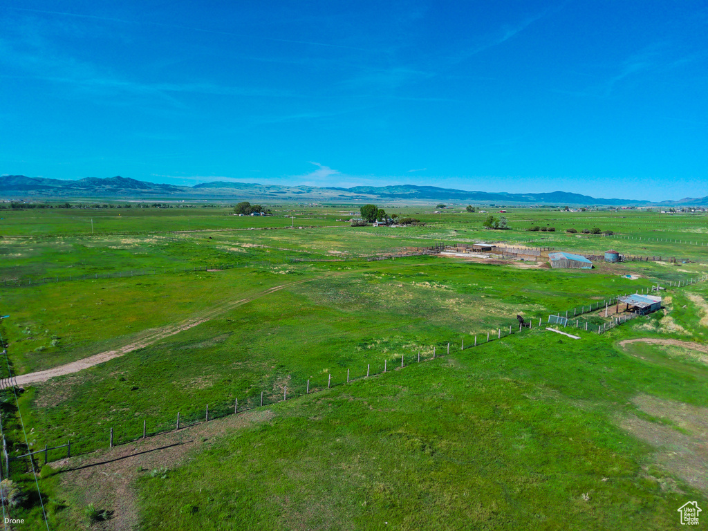 Overview of rural landscape with a mountain backdrop and agricultural land