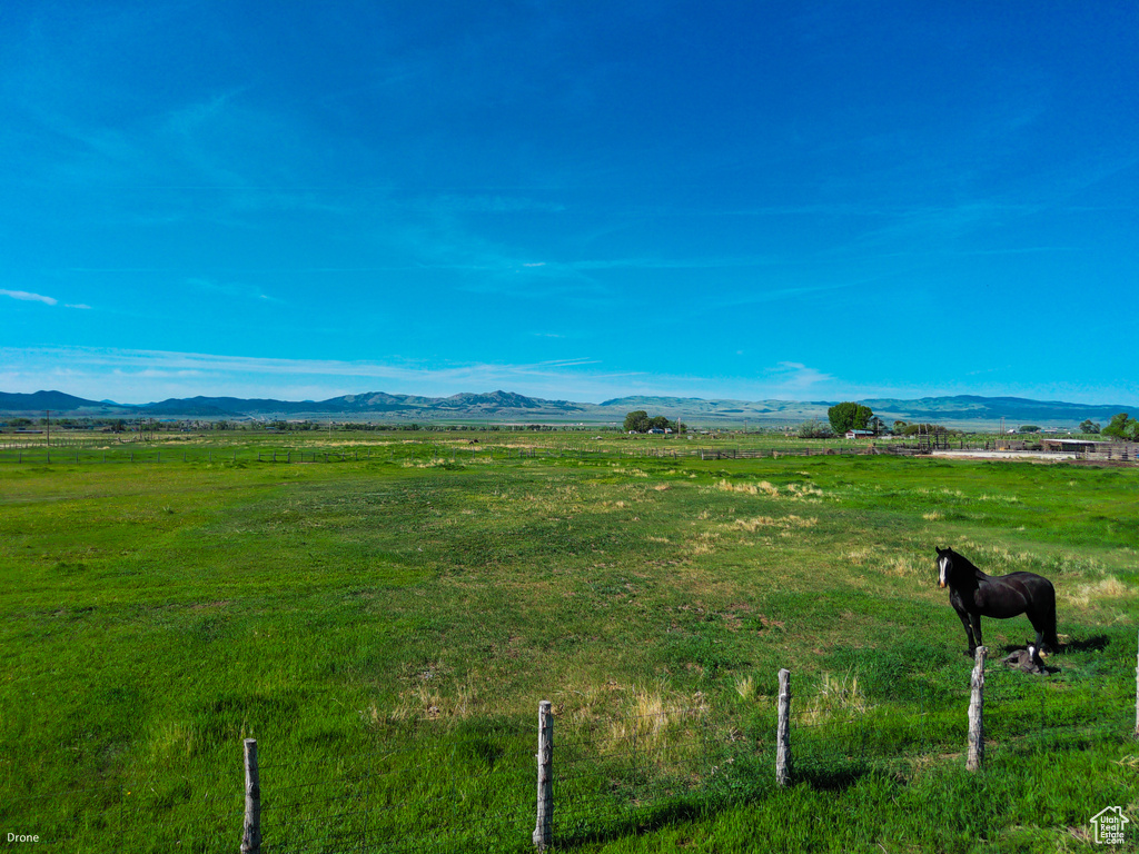 View of mountain backdrop featuring rural landscape and agricultural land