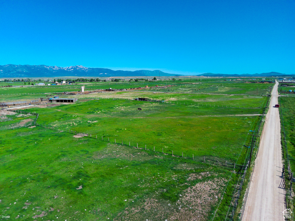 View of mountain backdrop with rural landscape and agricultural land