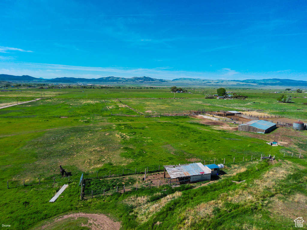 Aerial view of sparsely populated area with a pastoral area and a mountainous background
