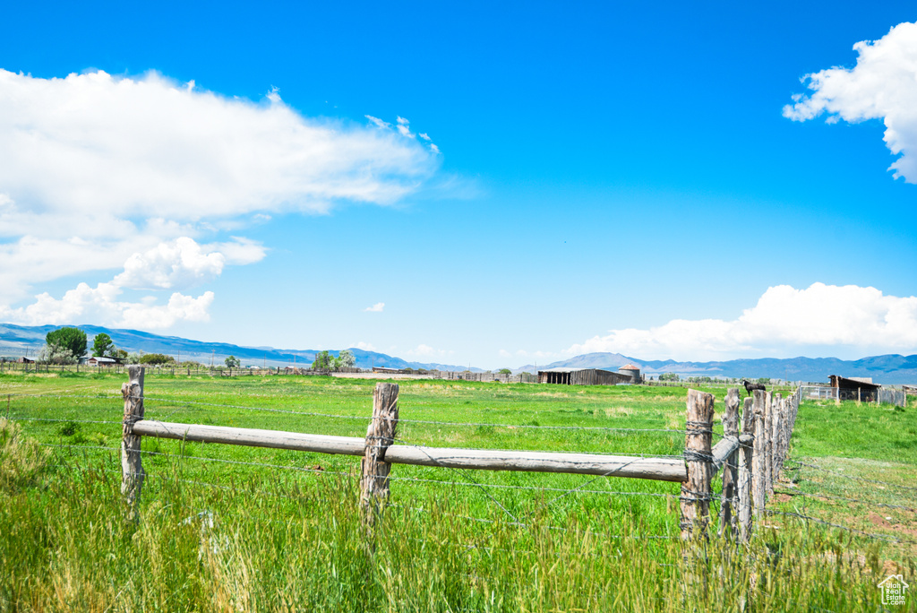 View of yard featuring a rural view and a mountain view
