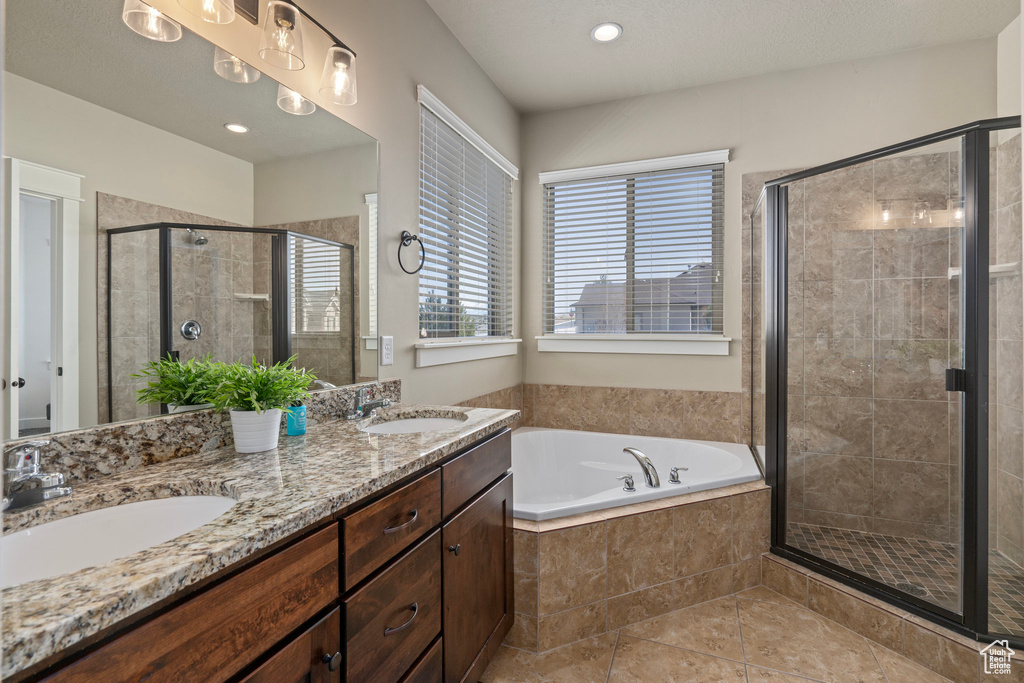 Bathroom with a sink, a stall shower, and a garden tub