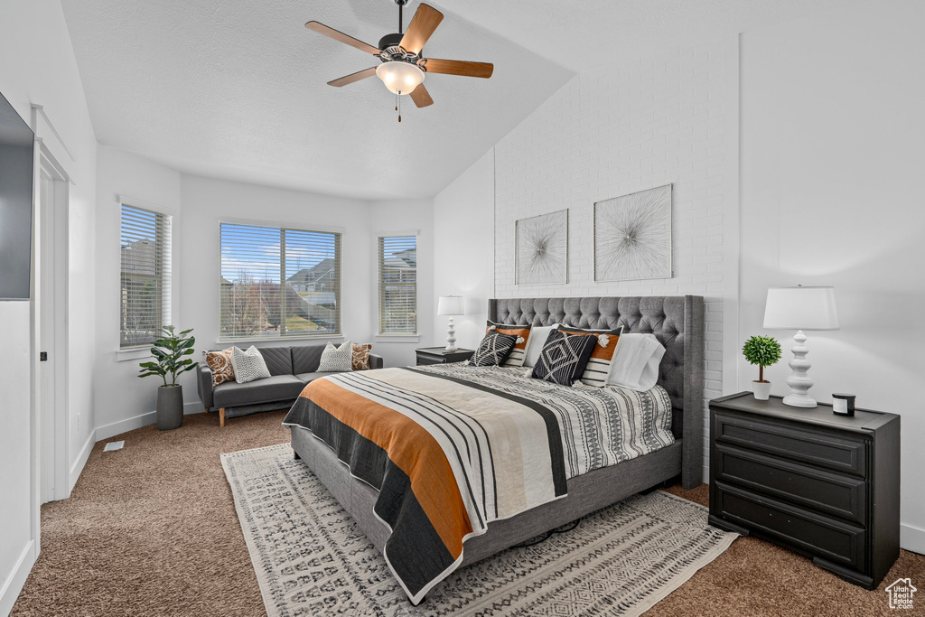 Bedroom featuring carpet flooring, baseboards, a ceiling fan, and lofted ceiling