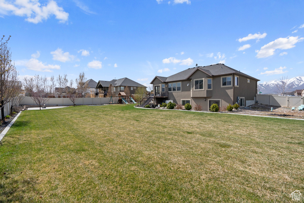 View of yard featuring a fenced backyard and a playground