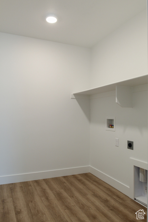 Washroom with baseboards, washer hookup, wood finished floors, laundry area, and electric dryer hookup