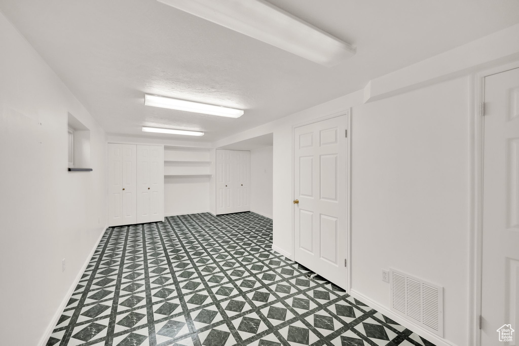 Finished basement with visible vents and baseboards