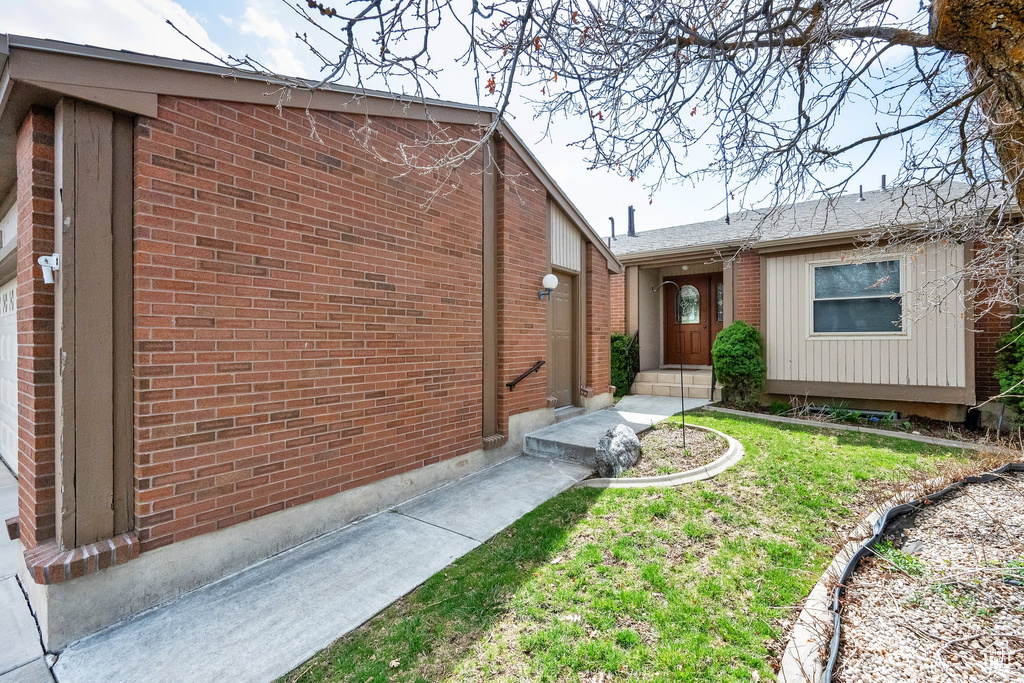 View of front of house featuring entry steps and brick siding
