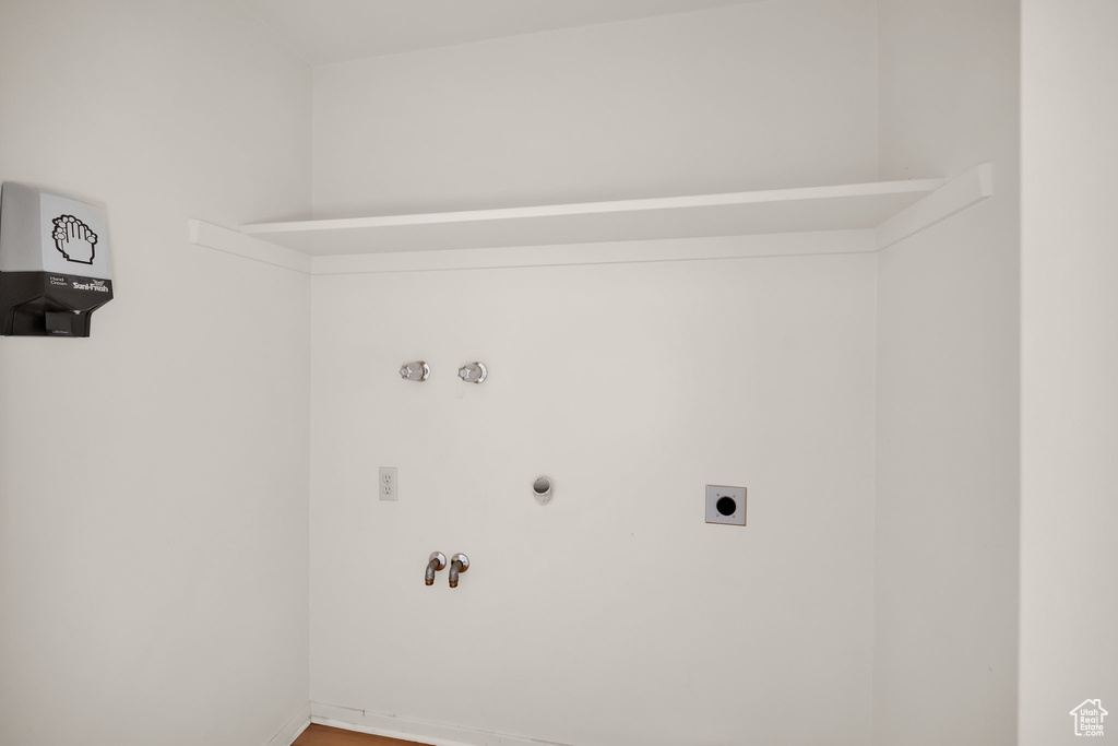 Clothes washing area with electric dryer hookup, hookup for a gas dryer, laundry area, and washer hookup