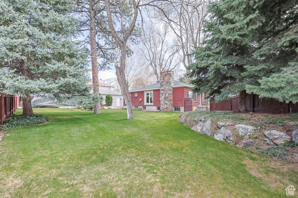 View of yard featuring fence
