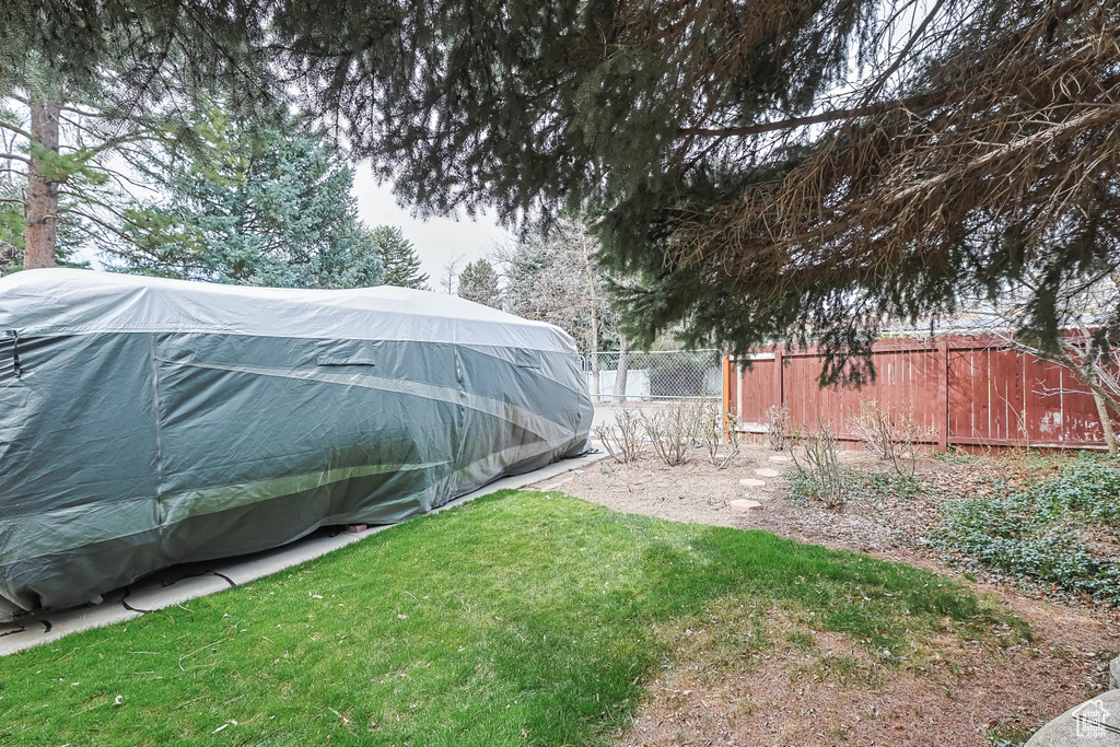 View of yard with an outbuilding and fence