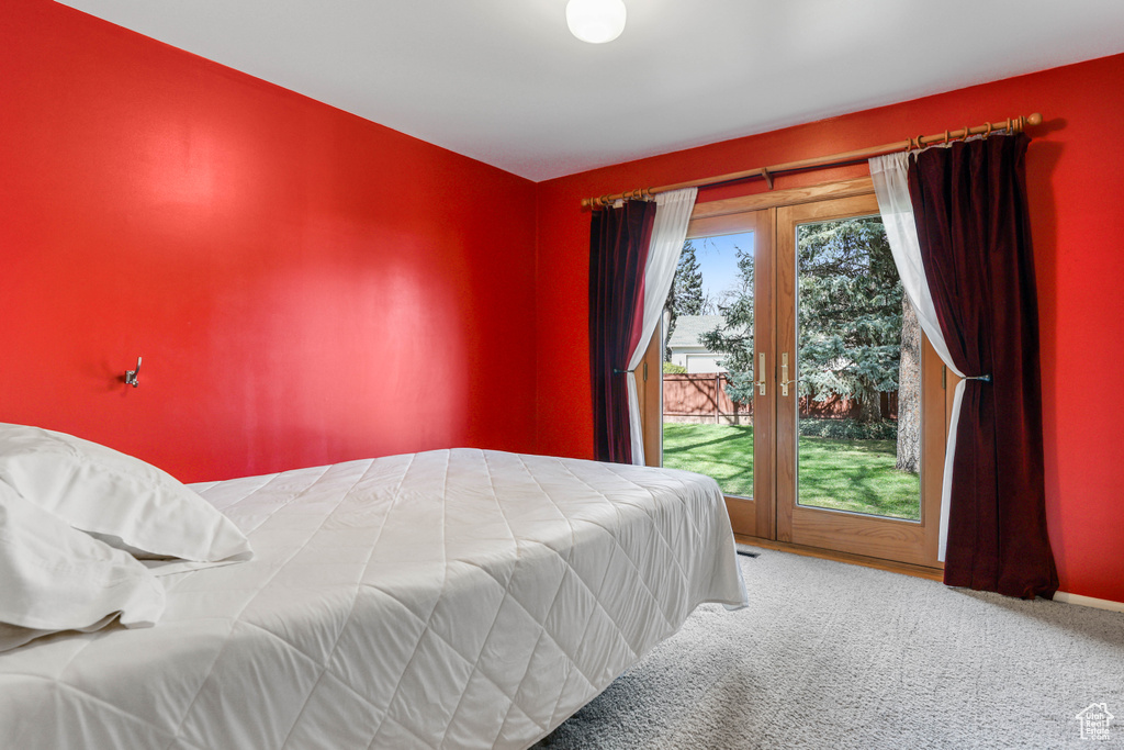 Bedroom featuring carpet floors, access to exterior, and baseboards