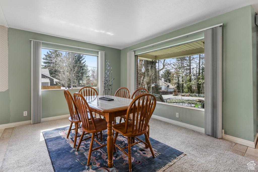 Carpeted dining area featuring baseboards