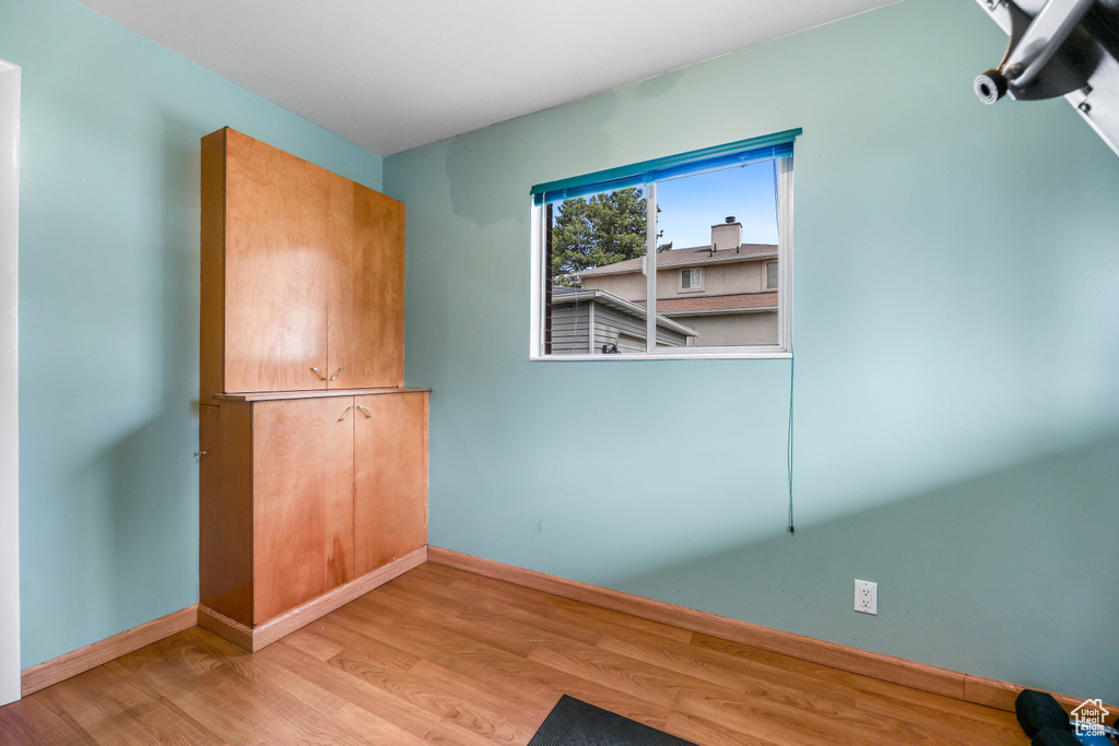 Spare room featuring light wood finished floors and baseboards