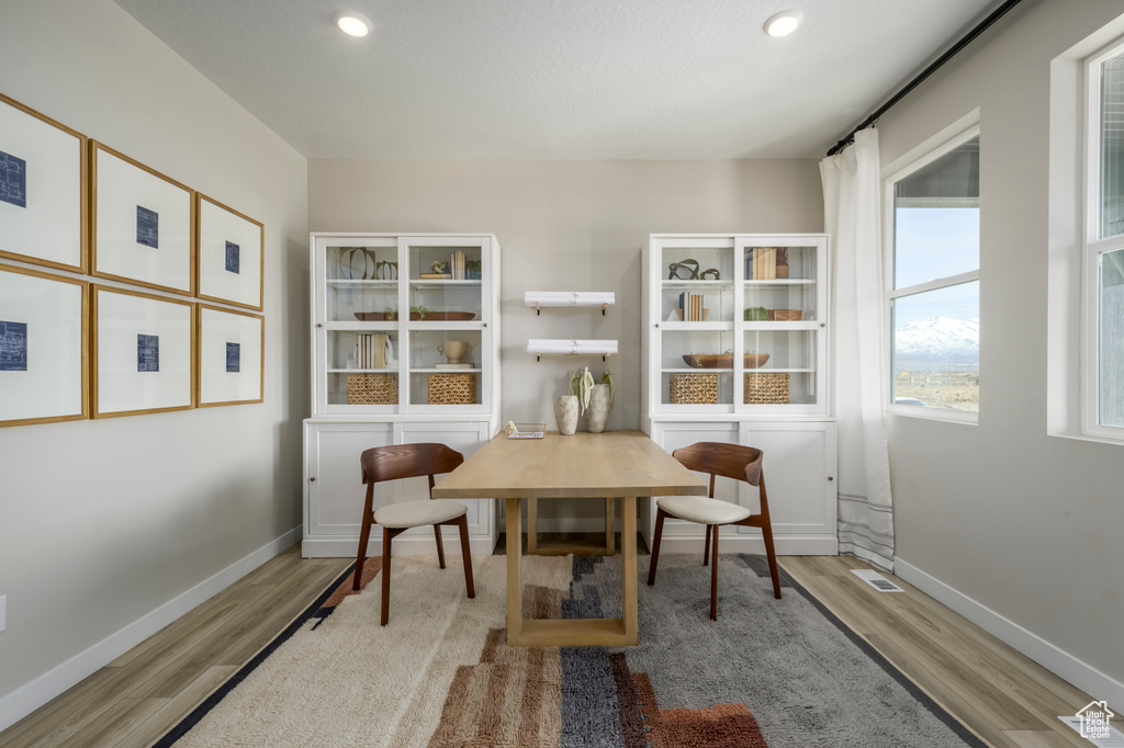 Home office with wood finished floors, baseboards, visible vents, and recessed lighting