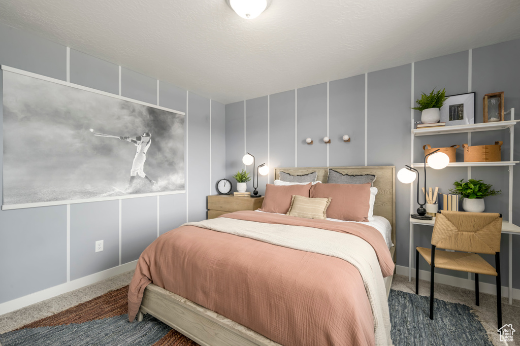 Carpeted bedroom with a decorative wall
