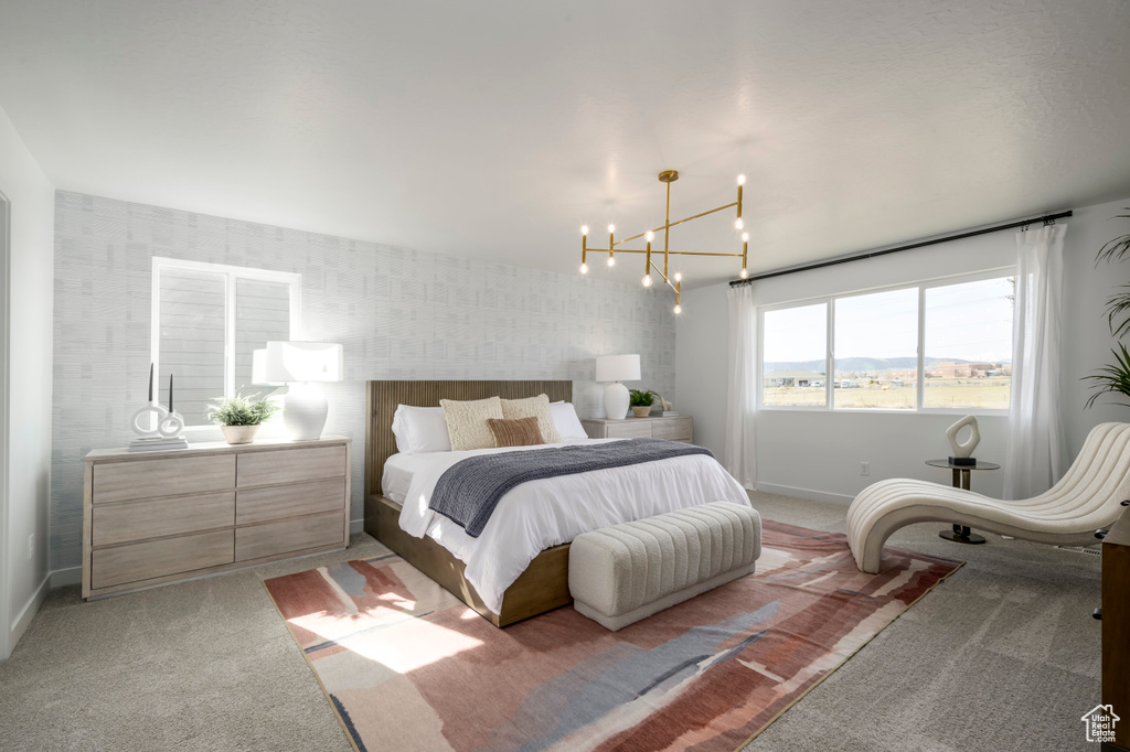 Bedroom with light carpet, wallpapered walls, a notable chandelier, and baseboards