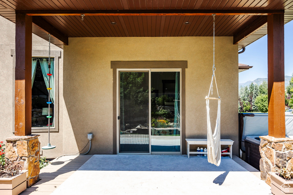 Entrance to property featuring a patio area, stucco siding, and a mountain view