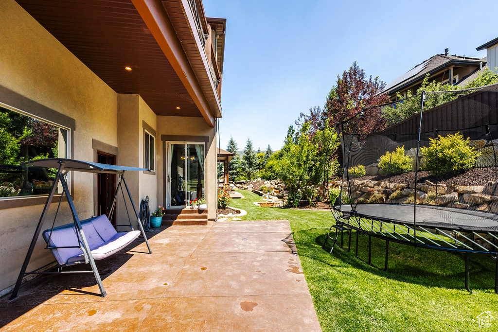 View of patio featuring entry steps and a trampoline