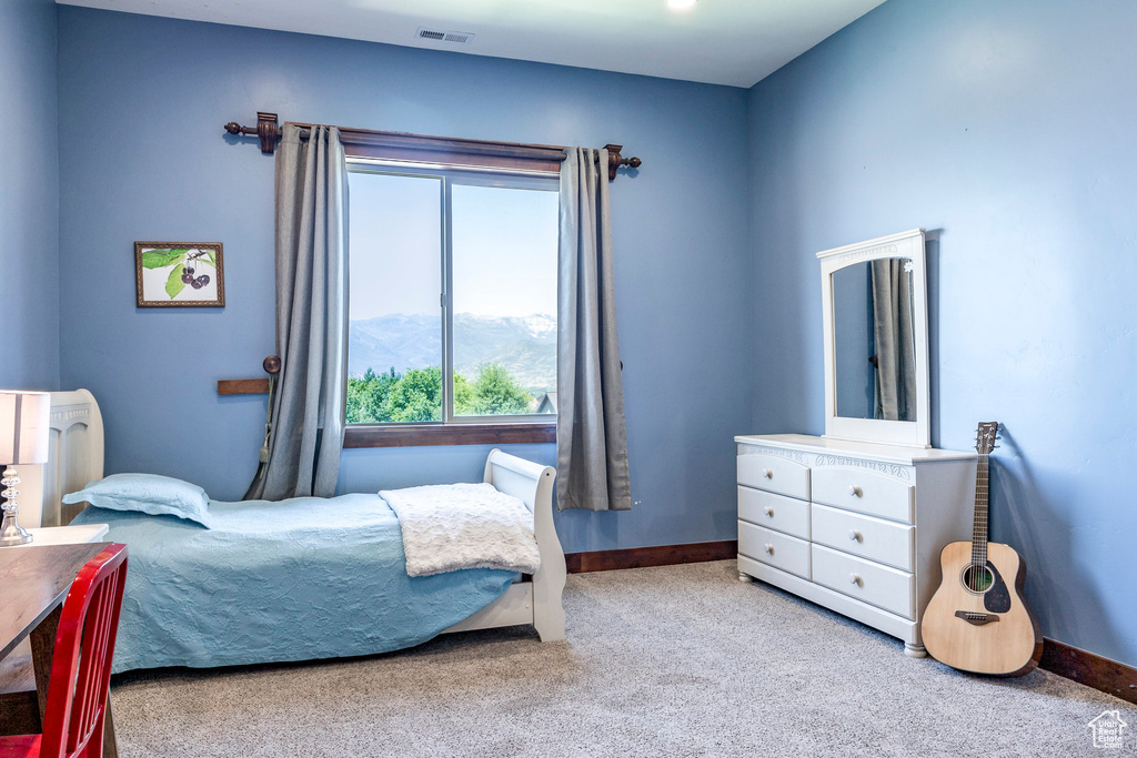 Bedroom featuring carpet, visible vents, baseboards, and a mountain view