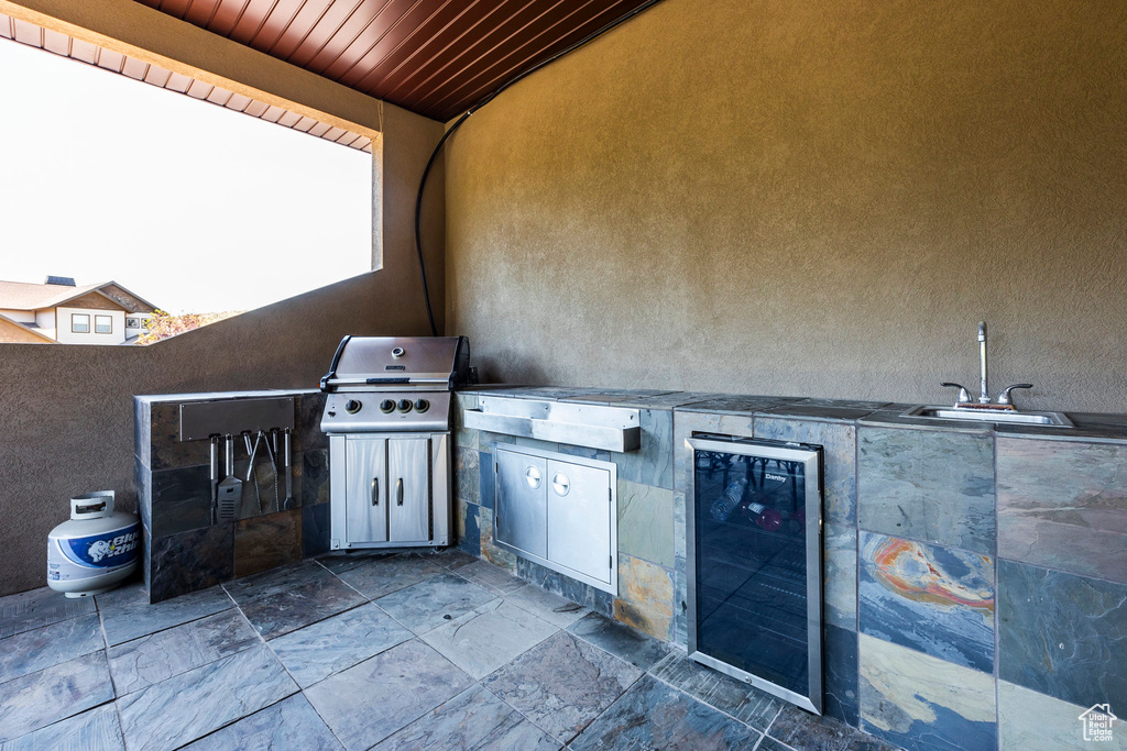View of patio / terrace featuring grilling area, area for grilling, a sink, and beverage cooler