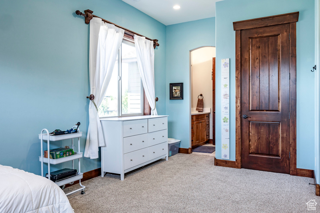 Bedroom with arched walkways, carpet flooring, and baseboards