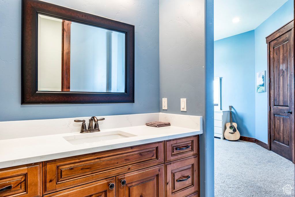 Bathroom featuring vanity and baseboards